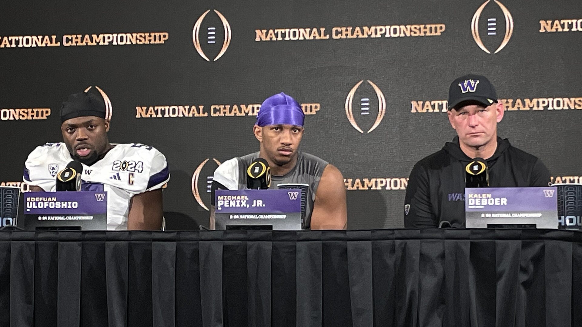 Washington Huskies' Edefuan Ulofoshio ( linebacker ), Michael Penix Jr. ( quarterback ), and Kalen DeBoer (head coach) at the post-game press conference in NRG Stadium after the 2024 College Football Playoff National Championship versus the