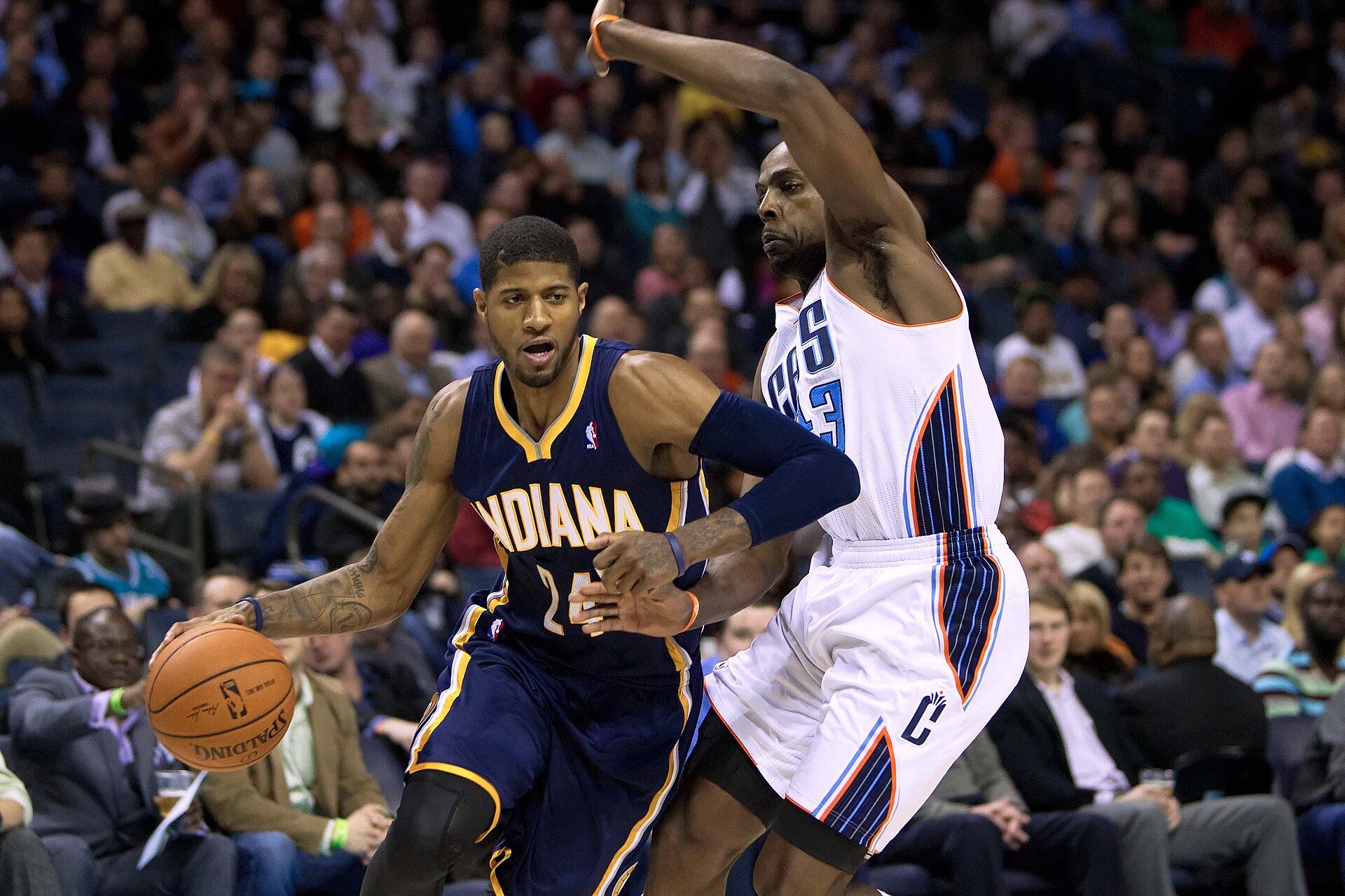 Mar 5, 2014; Charlotte, NC, USA; Indiana Pacers small forward Paul George (24) drives to the basket while being defended by Charlotte Bobcats power forward Anthony Tolliver (43) during the second half at Time Warner Cable Arena. Bobcats won